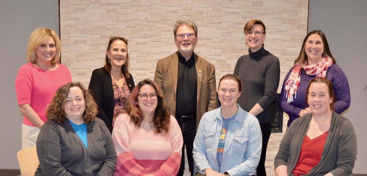 9 library board members pose for a photo